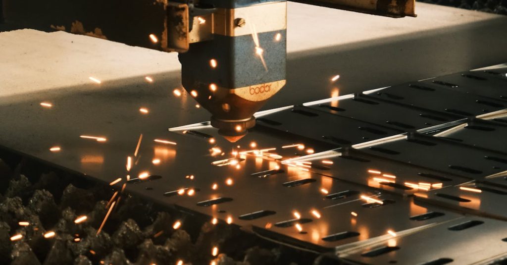 Close-up of a laser cutter in action, producing sparks in a modern manufacturing facility.